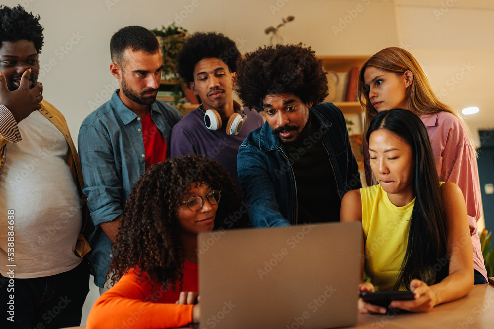 Office workers helping coworker with task. Office workers helping coworker with task.