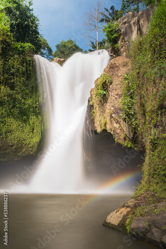 Tegenungan waterfall with rainbow in Bali photo
