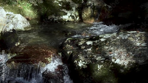 clear river water flowing over the rocks 2