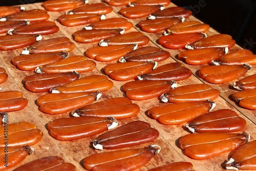 In Taiwan's Lukang Old Street, a shop uses wooden boards to Sun-dried mullet roe.