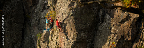 Rock climbers. Active lifestyle, risky hobbies, dangerous adrenaline sports background. Group of friends climbing Hradok rock wall in Slovakia.