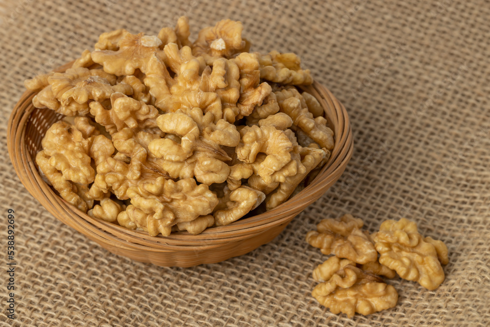Basket with peeled walnuts on burlap. Basket with peeled walnuts on burlap.