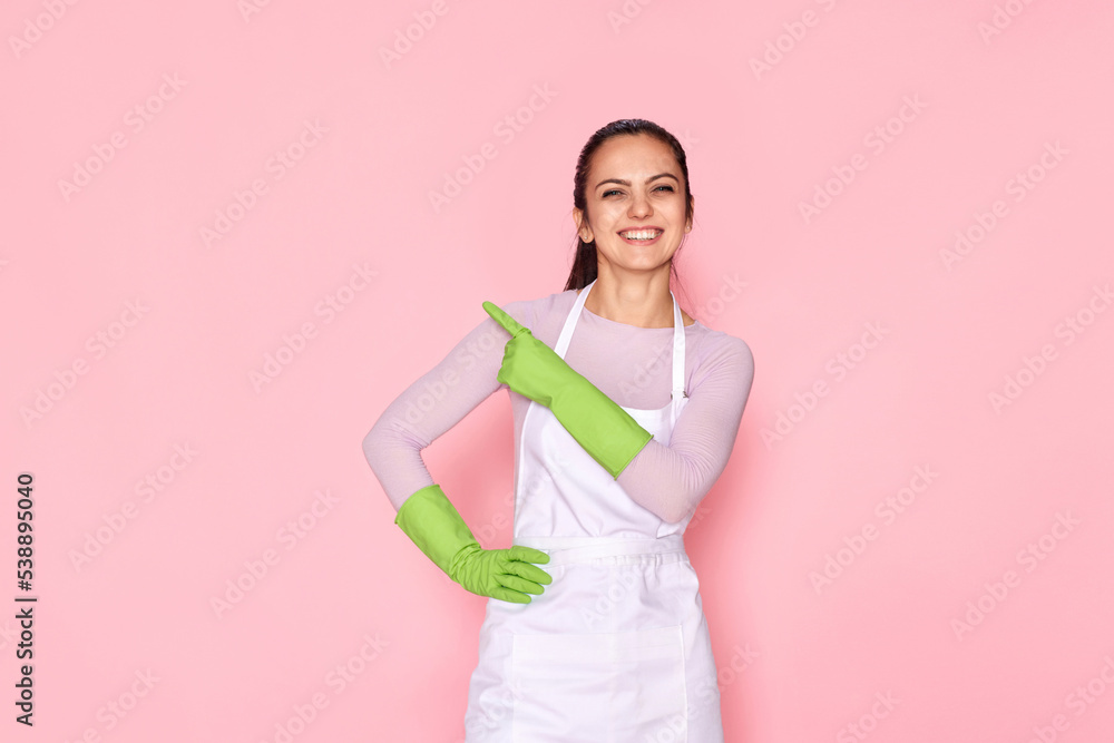 woman in rubber gloves pointing fingers aside at copyspace woman in rubber gloves pointing fingers aside at copyspace