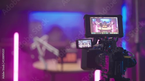 Behind the camera of podcast recording in kitchen with pink neon tubes 4K