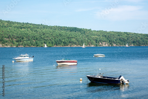 Boats at mooring and sailboats sailing in Willsboro Lake Champlain Bay