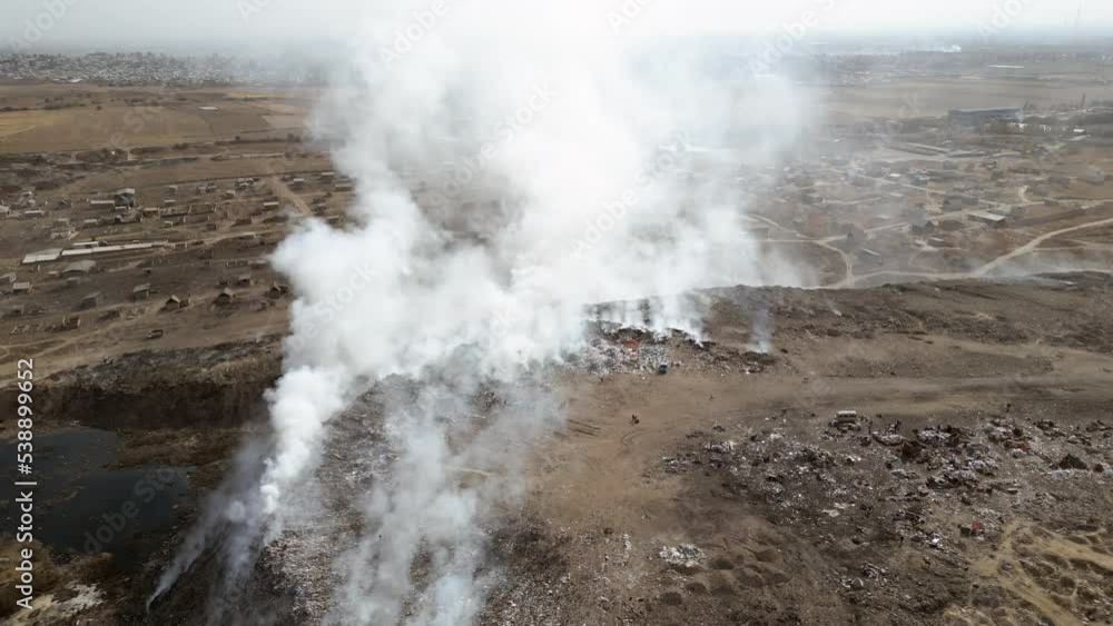 Aerial view of landfill with burning trash piles Aerial view of landfill with burning trash piles