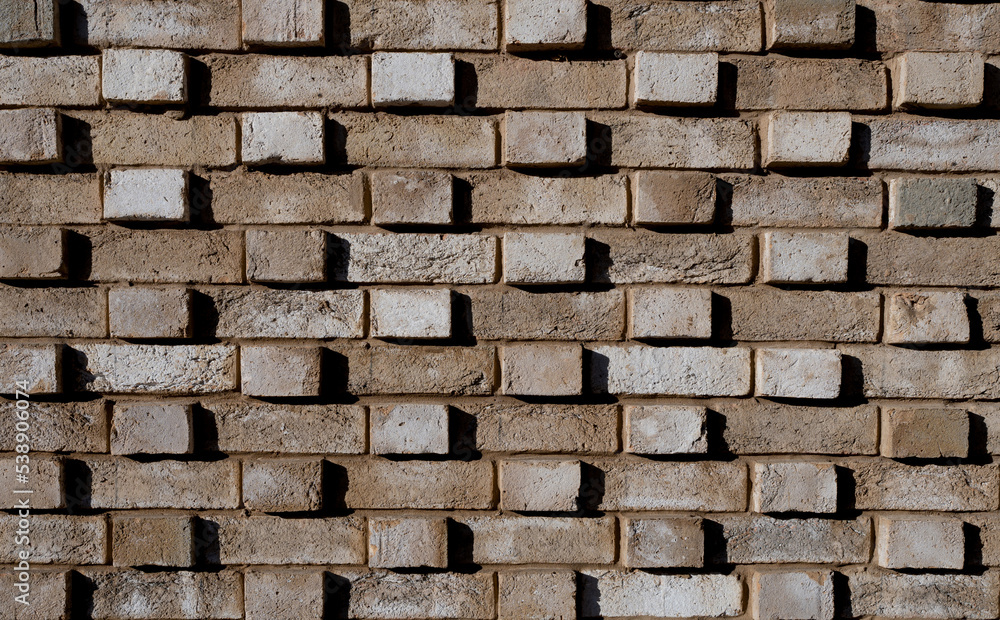 Brick wall with light and shadow, Brown grunge stones background, Horizontal backdrop Abstract with broken bricks texture, English heritage old Vintage house facade wall with cracks and scratches Brick wall with light and shadow, Brown grunge stones background, Horizontal backdrop Abstract with broken bricks texture, English heritage old Vintage house facade wall with cracks and scratches