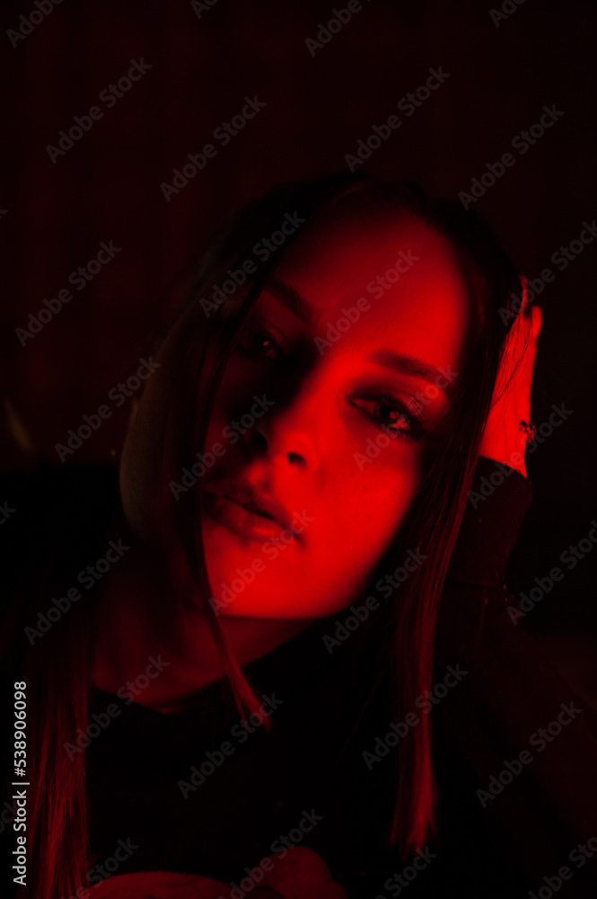 girl with a high ponytail in golf with a neckline in neon light red twilight darkness girl with a high ponytail in golf with a neckline in neon light red twilight darkness
