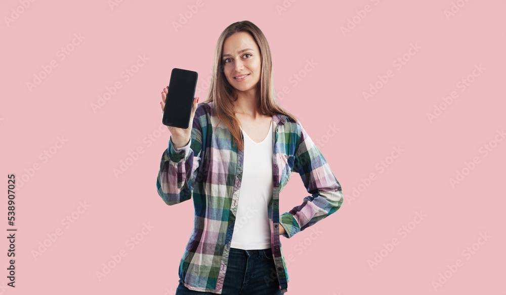 Happy woman holding a mobile phone with a blank screen Happy woman holding a mobile phone with a blank screen