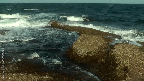 Waves crashing on rocks at Perce Beach on the Gaspé Peninsula 
Steady shot from Quebec Canada, 2021
 photo
