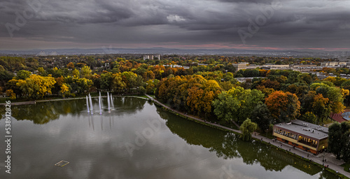 Drone view, aerial, landscape with lake (pond, lagoon), fountains and clouds - Zalew Nowohucki, Kraków Cracow, Poland, Europe, water reservoir,