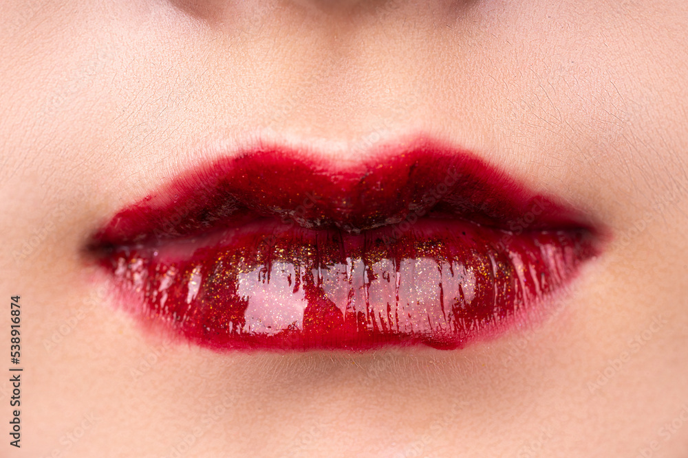 Obraz premium A woman's lips with red lipstick