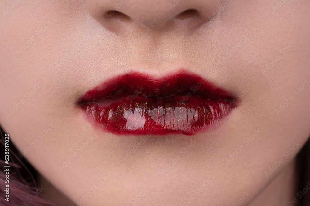 Fototapeta premium A woman's lips with red lipstick