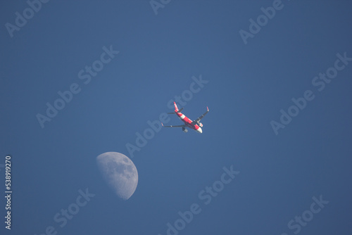 Passenger Airplane and the moon photo