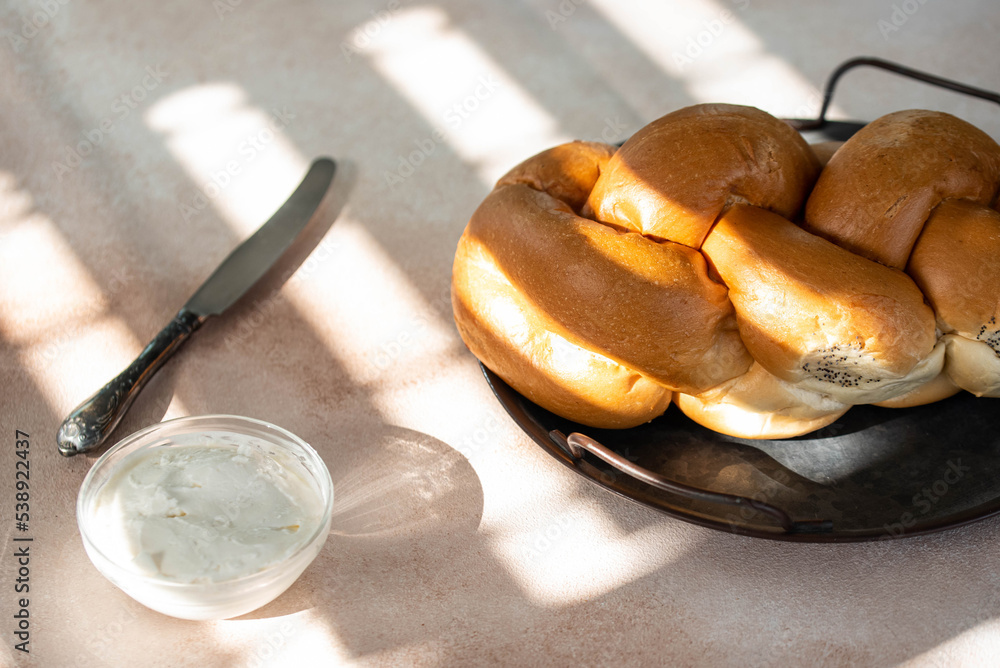 Fototapeta premium Challah Shabbat braided bread with silver knife and cottage cheese. Traditional Meal for Jewish cuisine Friday or Saturday dinner.