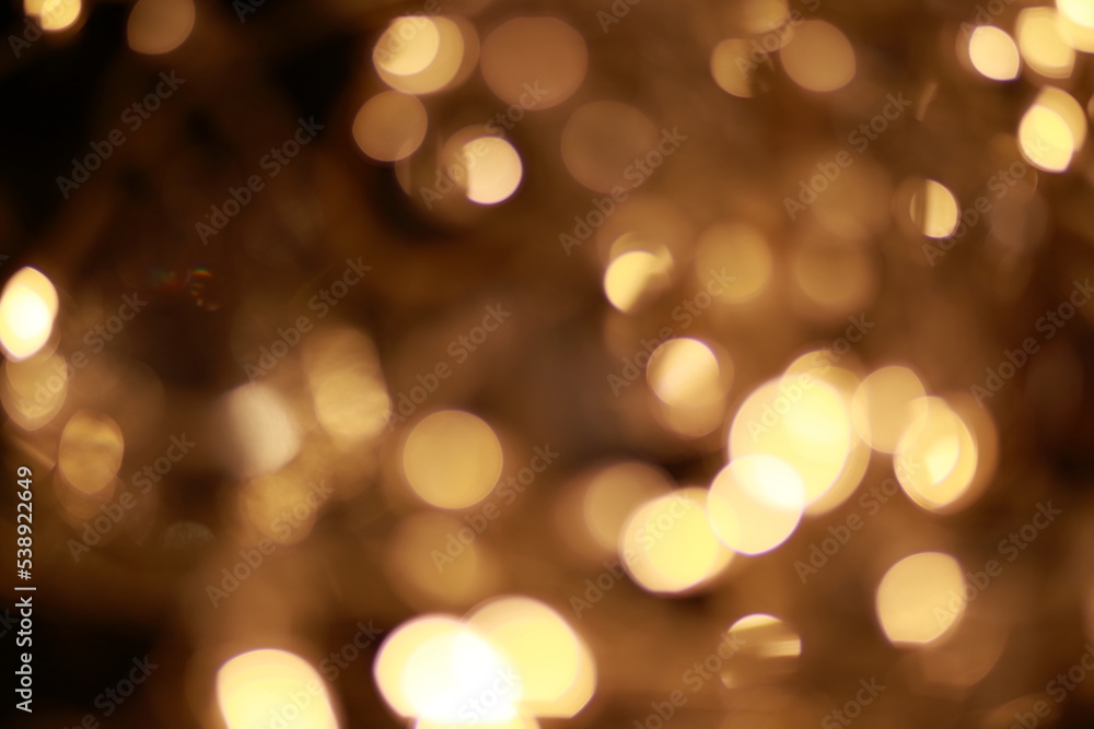 Christmas lights and garlands unfocused. Soft and gentle bokeh. Golden and warm.
