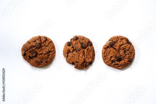 Collection of half chocolate chip cookies on white background. 