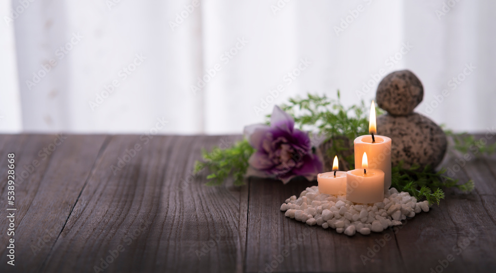 Spa aromatherapy concept. Decoration with candles, stones plants on wooden table