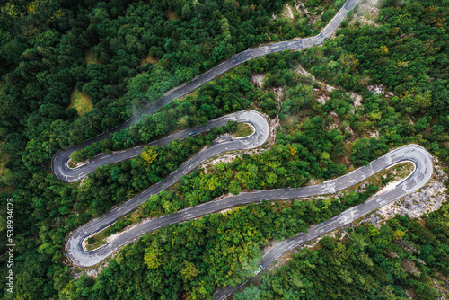 Road with serpentines in the mountains with forest