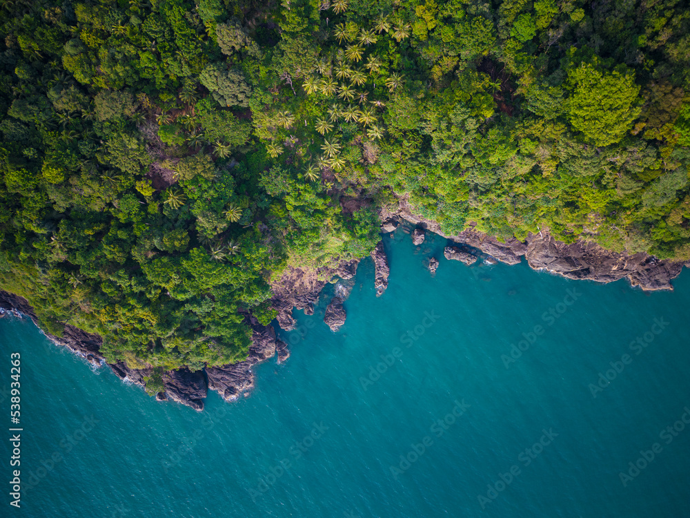 Aerial view sea beach wave with green tree mountain forest in tropical island Aerial view sea beach wave with green tree mountain forest in tropical island