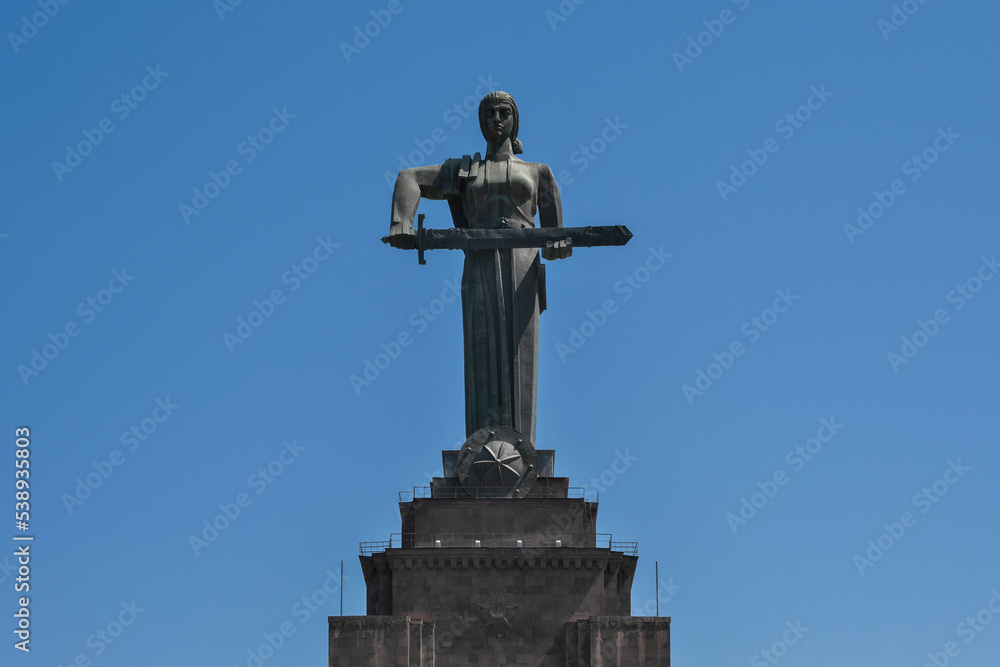 View of Mother Armenia Statue on sunny day on the background of blue sky. Yerevan, Armenia.
