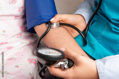 Measuring the blood pressure senior woman