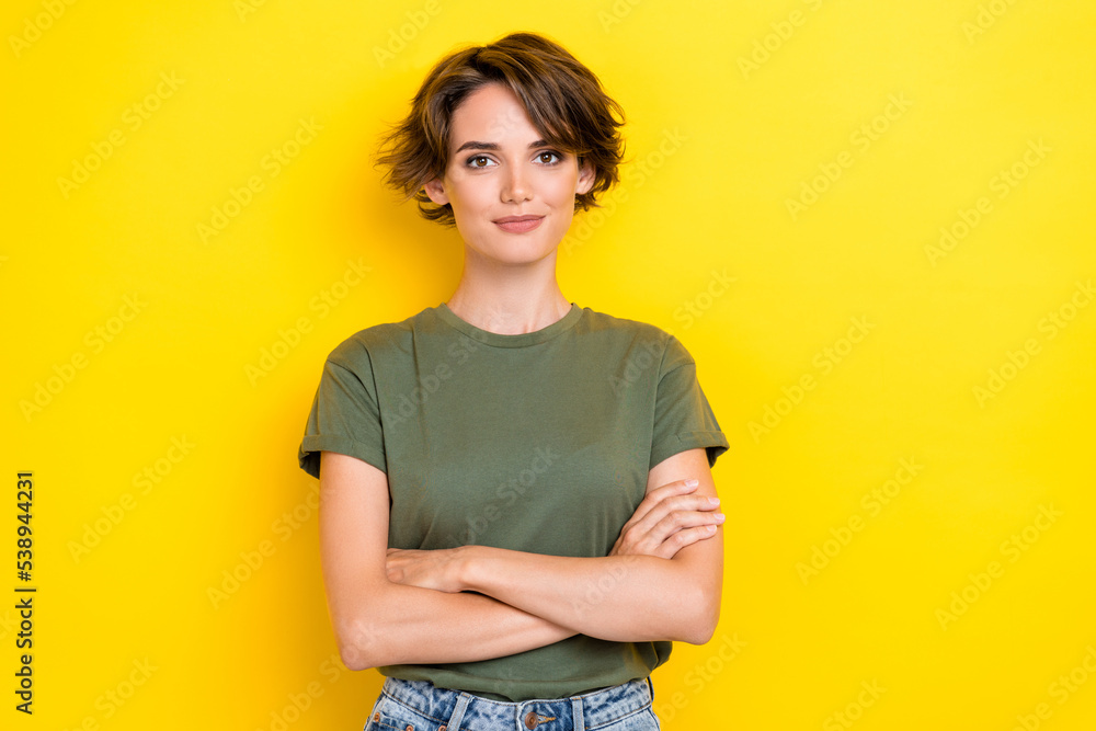Photo of girlish pretty confident nice girl with bob hairstyle wear khaki t-shirt arms crossed isolated on yellow color background Photo of girlish pretty confident nice girl with bob hairstyle wear khaki t-shirt arms crossed isolated on yellow color background