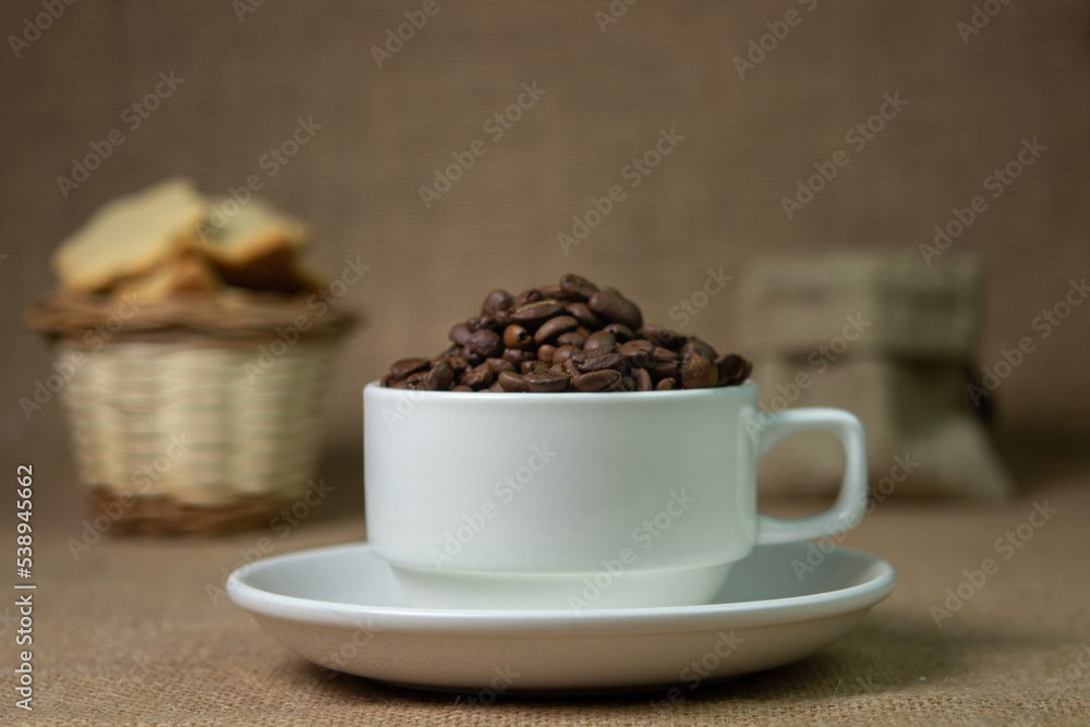 White cup full of coffee beans. natural coffee drink