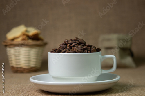 White cup full of coffee beans. natural coffee drink