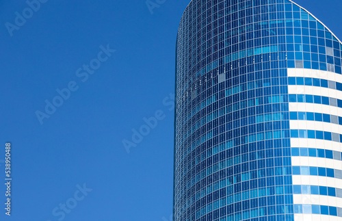 Skyscraper building against the blue sky closeup