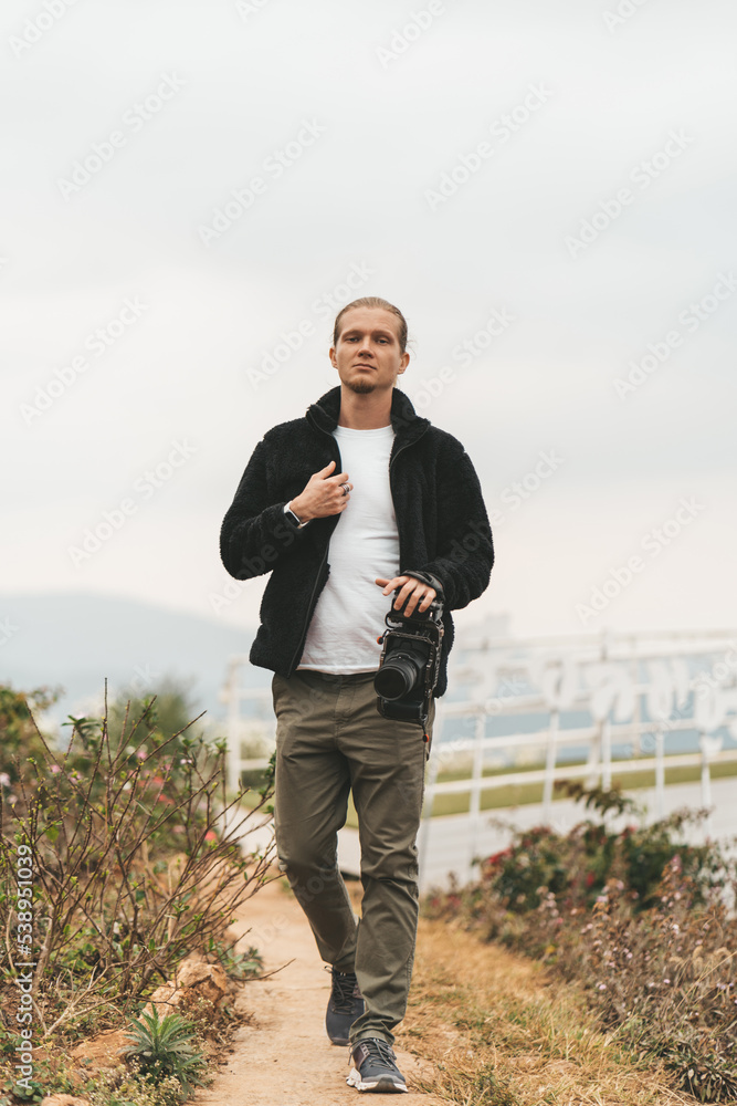 Man is standing on a high viewpoint with video camera Man is standing on a high viewpoint with video camera