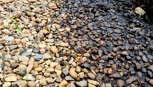 Oil spill on rocks, selective focus.