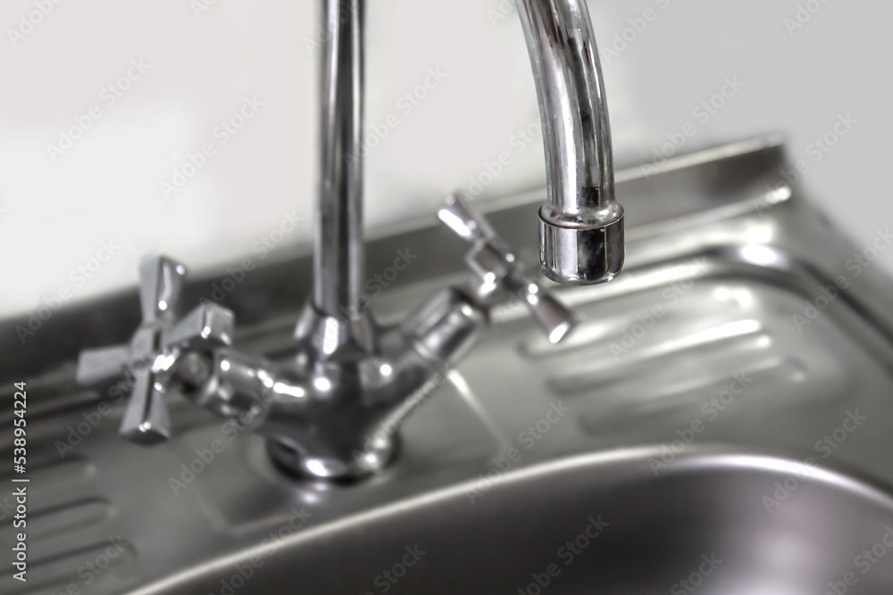 Kitchen water mixer. Water tap made of chrome material Kitchen water mixer. Water tap made of chrome material