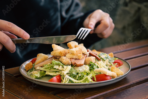 Salad with vegetables, bacon and chicken, close-up.