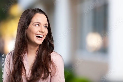 Young woman feeling happy and posing with a big smile