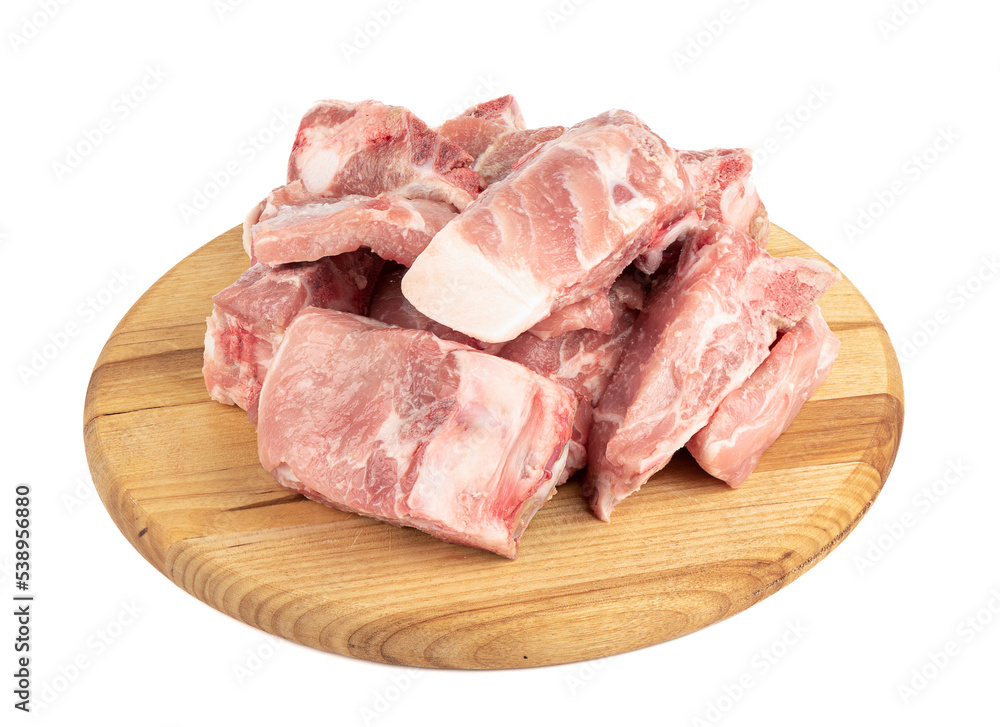 Fresh pork meat with bones on a cutting board isolated on white background. Fresh pork meat with bones on a cutting board isolated on white background.