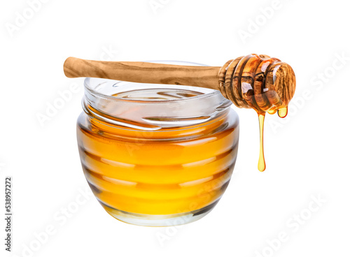 Honey isolated on white or transparent background. Jar with honey and honey dipper with drop of honey photo