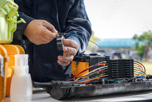 Engineer or technician are install fiber optic cable lines for maintenance.