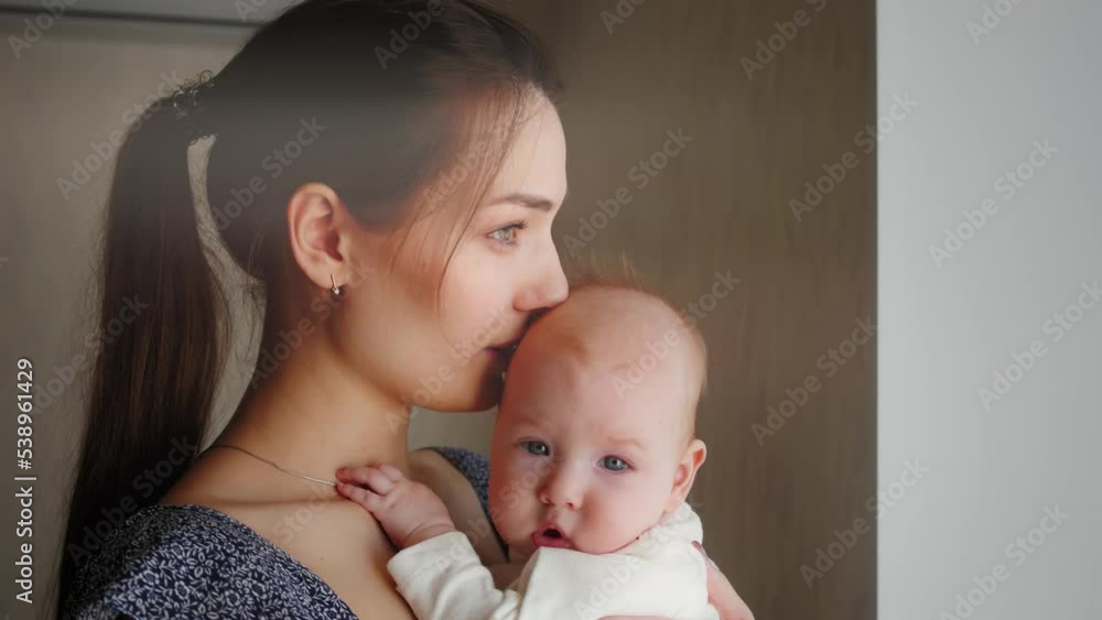 Young Mother Holding her Newborn Sleeping Child. Family at home, woman with baby. Young Mother Holding her Newborn Sleeping Child. Family at home, woman with baby.