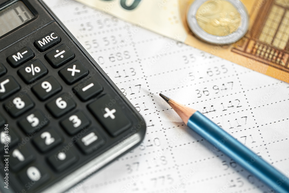 Calculator, money and pencil close-up on a blurred background. Calculator, money and pencil close-up on a blurred background.