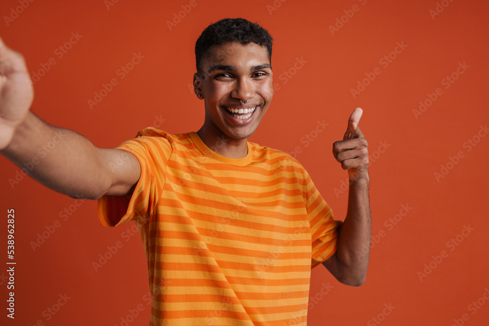 Selfportrait of young handsome smiling happy african man in t-shirt Selfportrait of young handsome smiling happy african man in t-shirt