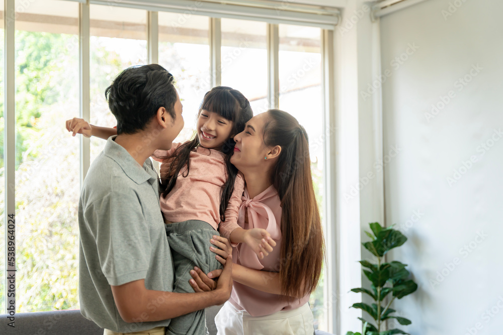 Asian family photo There are fathers, mothers and daughters. The father is the one holding the daughter. and having fun at home on the weekend Asian family photo There are fathers, mothers and daughters. The father is the one holding the daughter. and having fun at home on the weekend