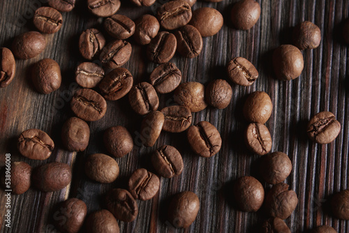 Coffee beans on wood background. Top view. Close up