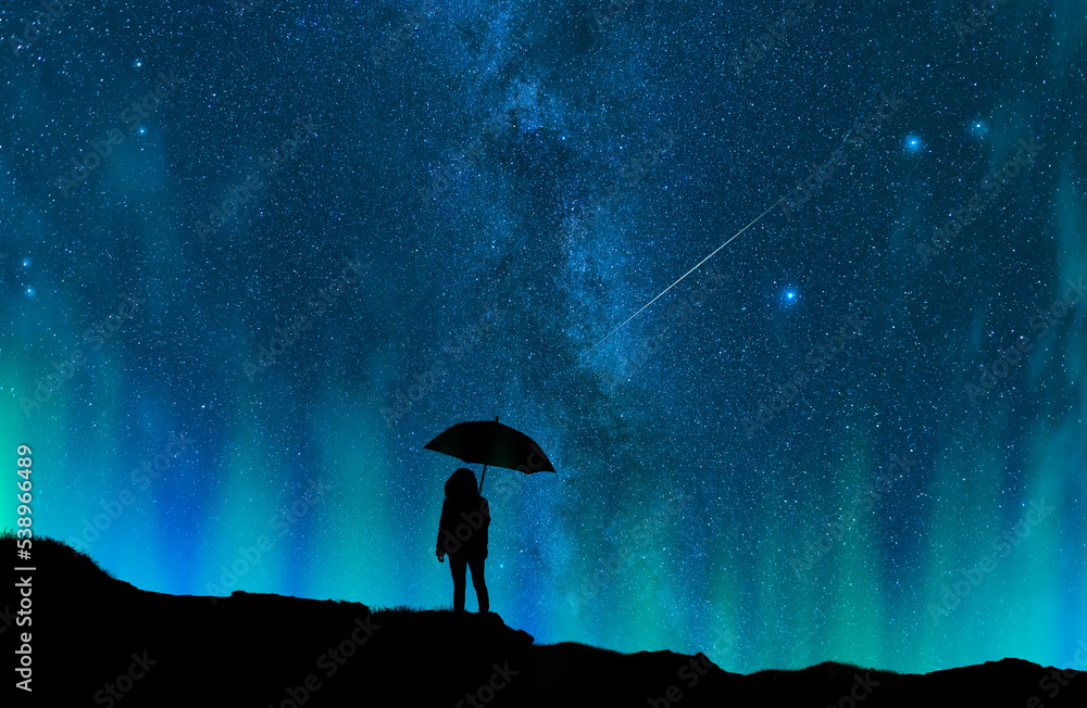 Silhouette of a person with umbrella under starry sky. Fantasy landscape.