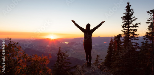 Adventurous Woman Hiking in Canadian Landscape with Fall Colors during sunny sunset. Elk Mountain  Chilliwack  East of Vancouver  British Columbia  Canada. Adventure Travel Concept