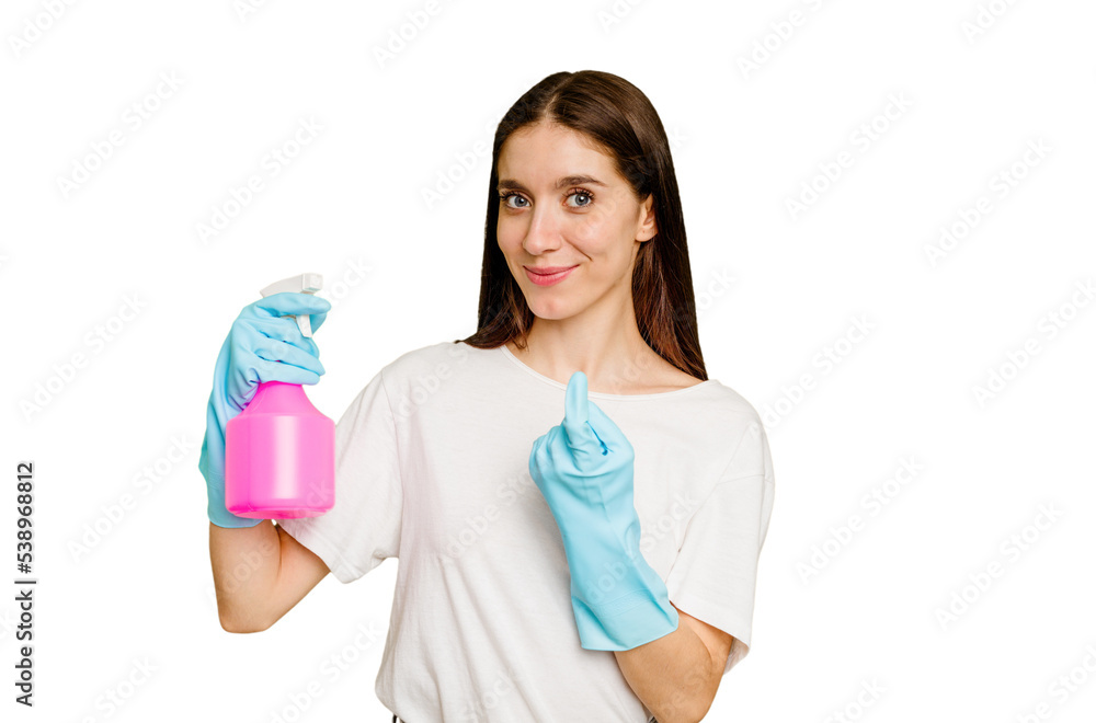 Young cleaner woman isolated pointing with finger at you as if inviting come closer. Young cleaner woman isolated pointing with finger at you as if inviting come closer.