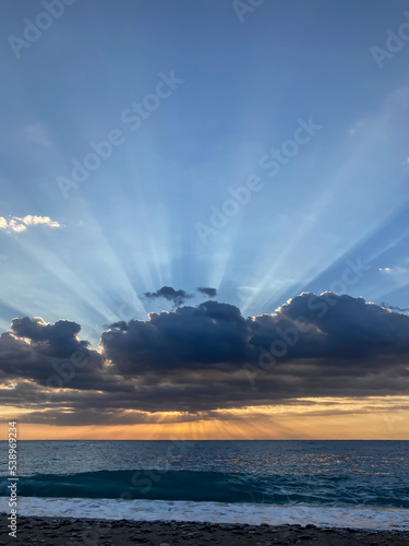 Sunrise landscape with clouds and sea. View of the sun rising above the sea. Selective focus. © jineps