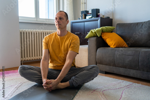 man practicing fitness with online training on laptop