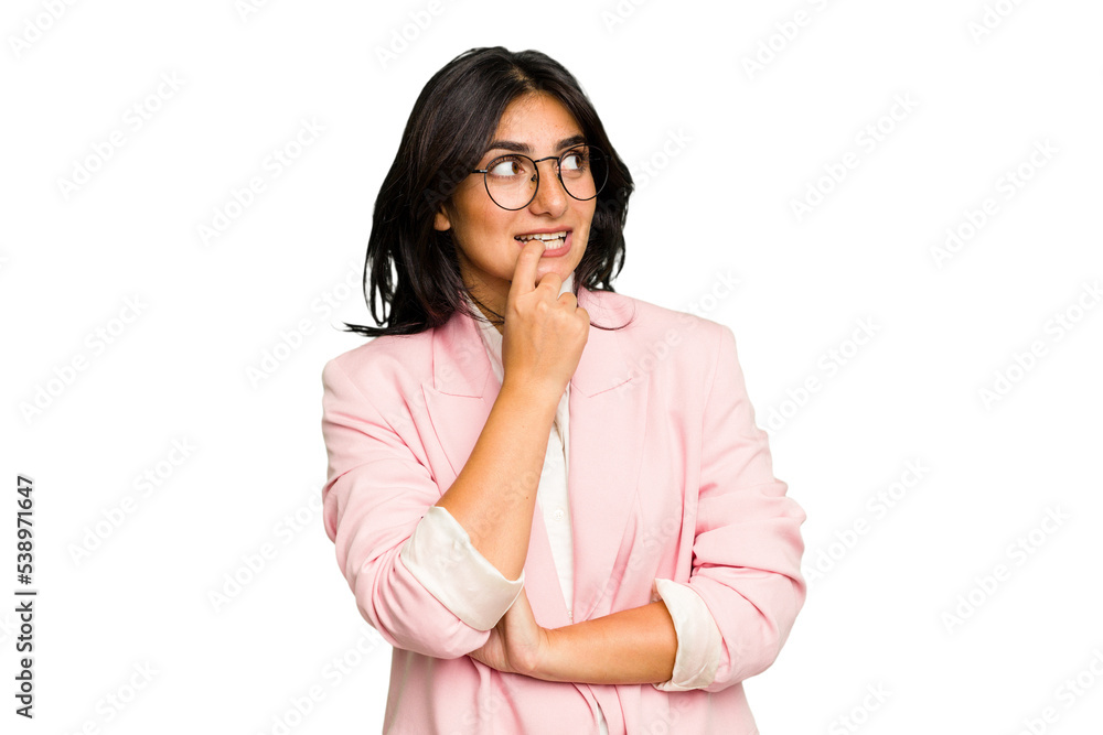 Young Indian business woman wearing a pink suit isolated relaxed thinking about something looking at a copy space. Young Indian business woman wearing a pink suit isolated relaxed thinking about something looking at a copy space.