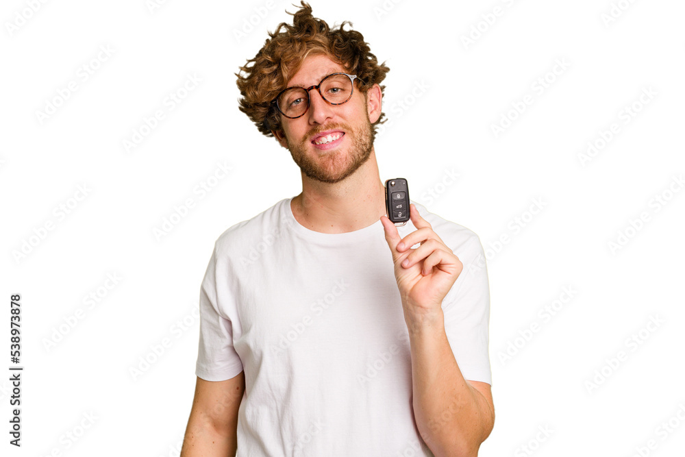 Young caucasian man holding car keys isolated on white background happy, smiling and cheerful. Young caucasian man holding car keys isolated on white background happy, smiling and cheerful.